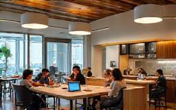 People interacting casually in a bright, modern shared office space or lounge